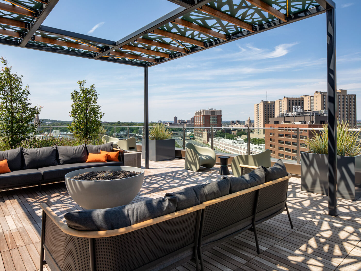 Terrace seating area with two couches and a fire pit